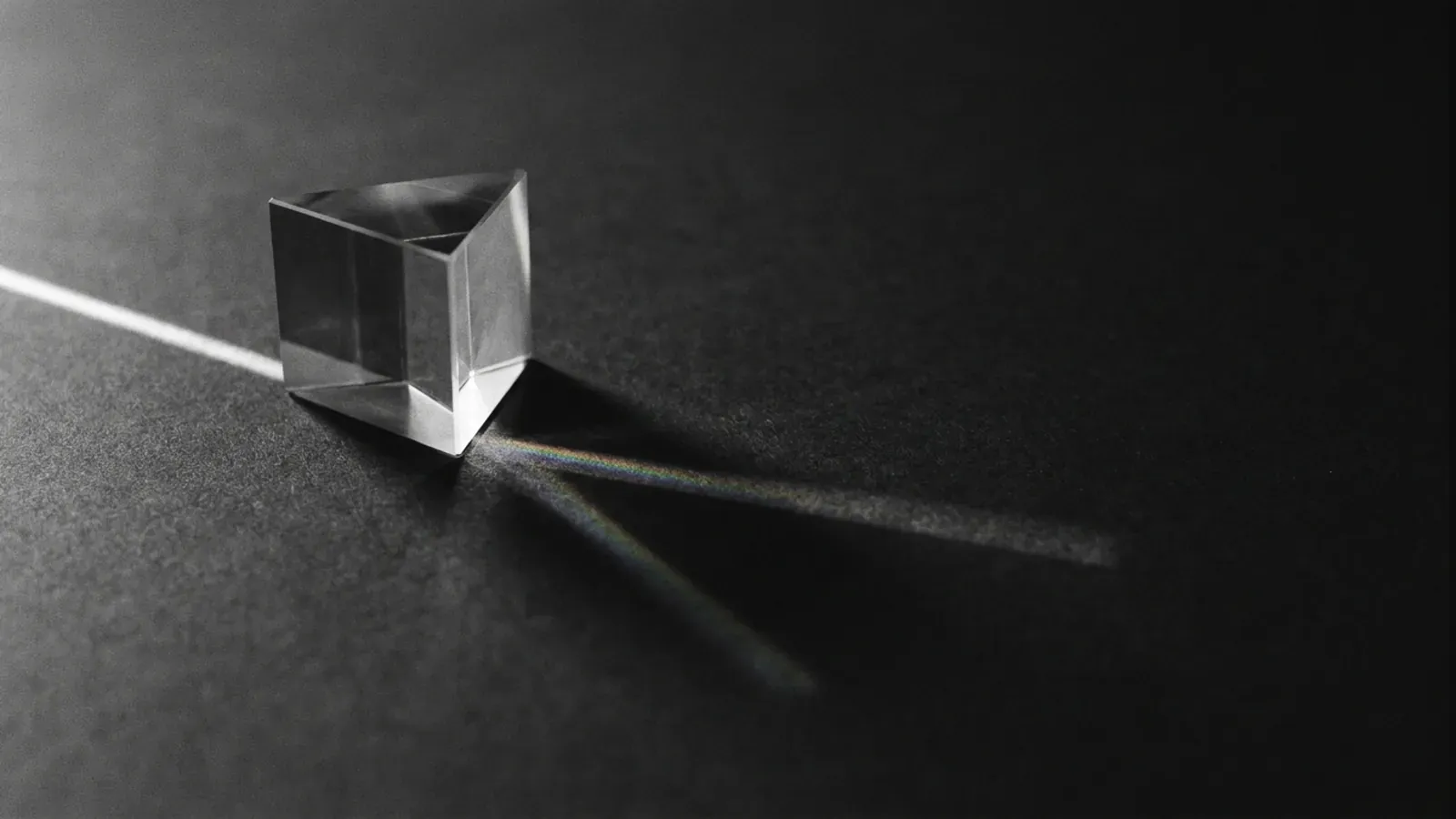 A glass prism splitting one beam of light into a spectrum, standing in for the biases that bend how a model is judged
