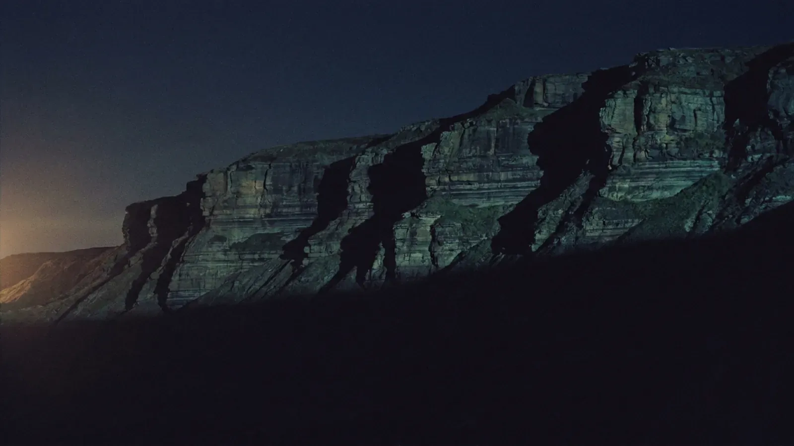 Layered rock strata, each band laid down on the one beneath it, standing in for the four layers of the 2026 agent stack