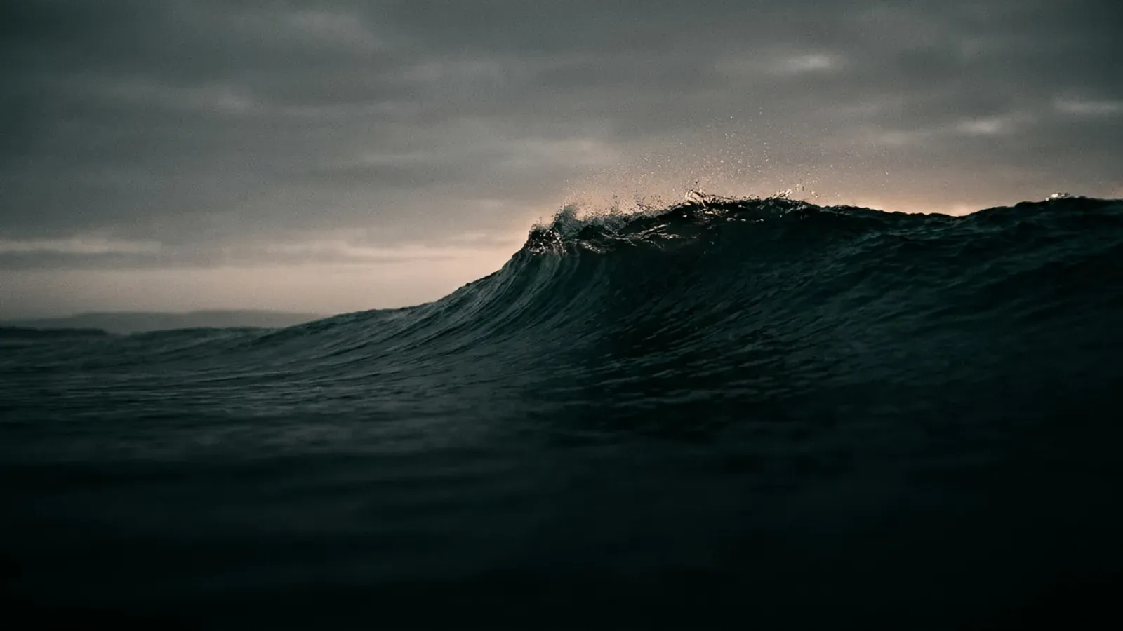A dark ocean wave lifting before it breaks, standing in for a new wave of AI models